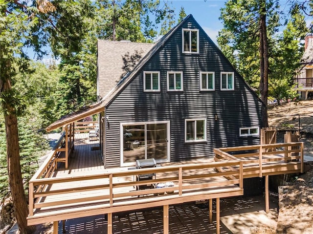 back of house with a wooden deck