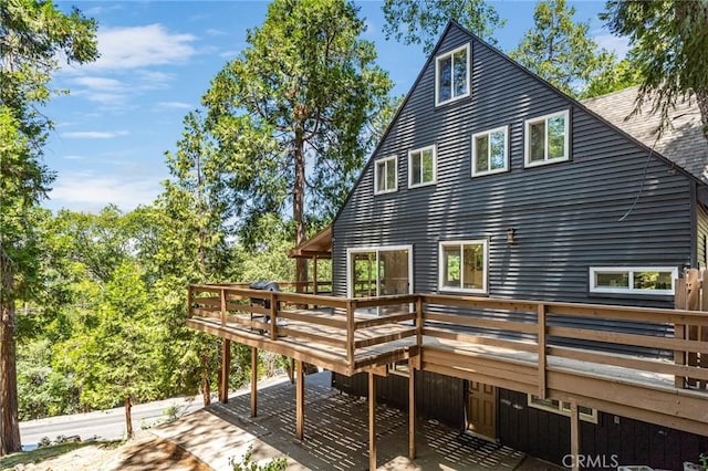 rear view of property featuring a deck