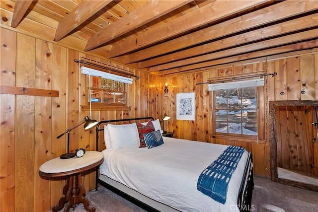 bedroom with wood walls, beamed ceiling, wooden ceiling, and dark colored carpet