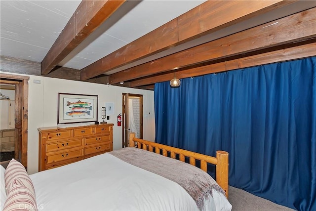 carpeted bedroom featuring beamed ceiling