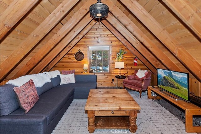 interior space featuring vaulted ceiling with beams, wood walls, and wooden ceiling