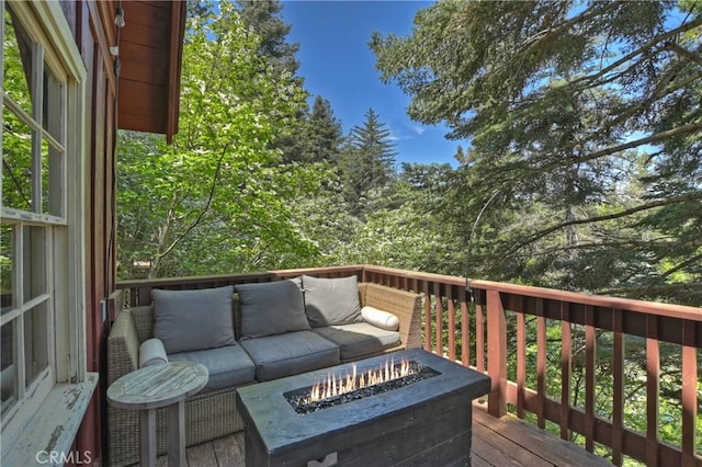 wooden terrace featuring a fire pit