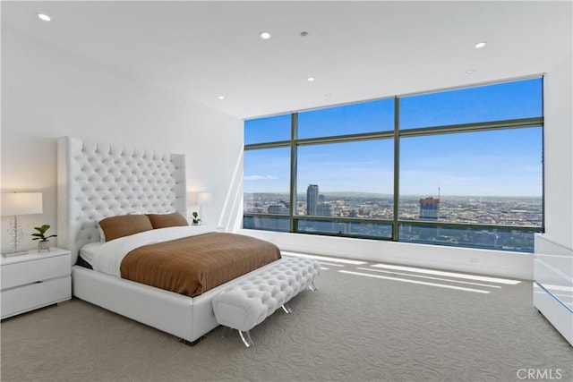 bedroom featuring carpet flooring and a wall of windows