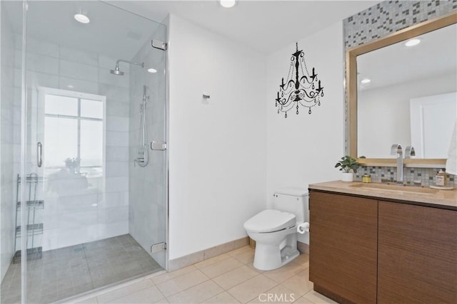 bathroom with tile patterned flooring, backsplash, an enclosed shower, toilet, and vanity