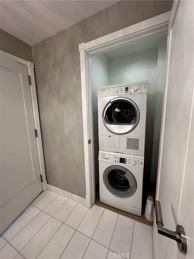 900 W Olympic Blvd Unit 42A, Los Angeles, CA 90015 - laundry area featuring stacked washer / drying machine and light tile patterned floors
