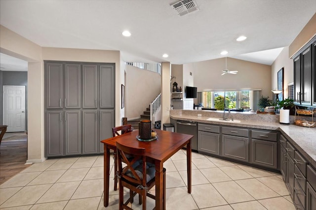 kitchen with gray cabinetry, dishwasher, light tile patterned flooring, and sink