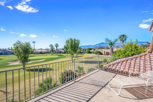 view of patio with a mountain view and a balcony