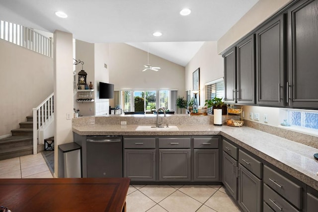 kitchen with ceiling fan, sink, stainless steel dishwasher, vaulted ceiling, and light tile patterned floors