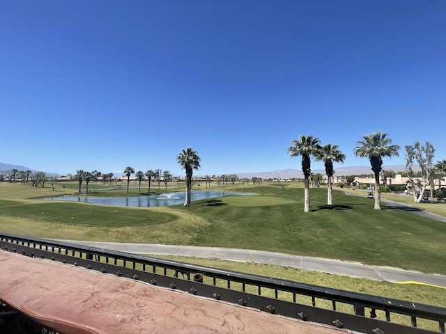 surrounding community with a lawn and a water and mountain view