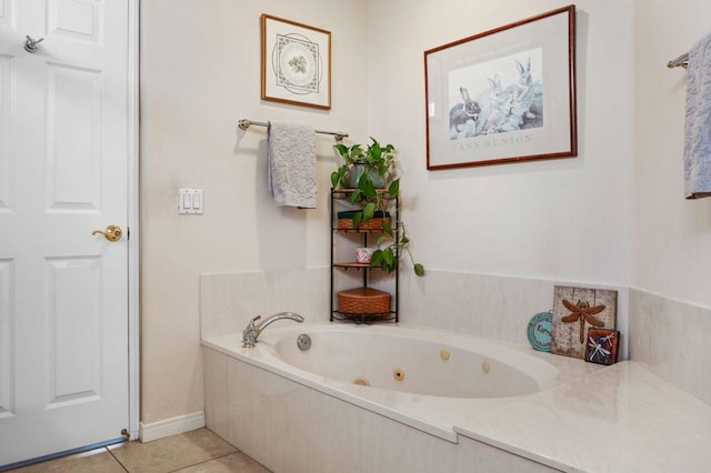 bathroom with tile patterned flooring and a tub