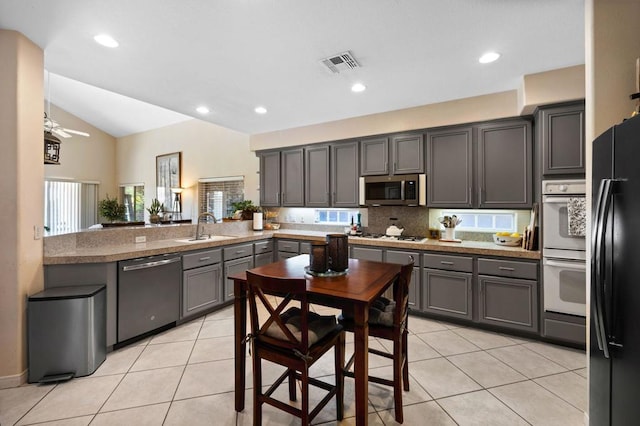 kitchen with gray cabinetry, ceiling fan, sink, stainless steel appliances, and kitchen peninsula