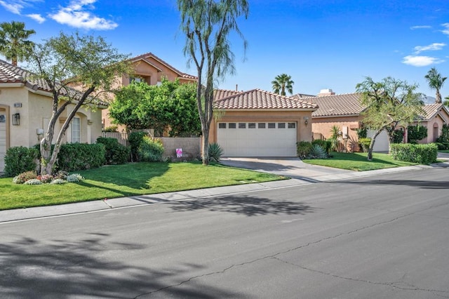 mediterranean / spanish home with a garage and a front lawn