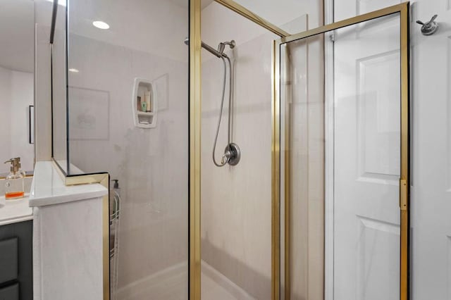 bathroom with vanity and a shower with shower door