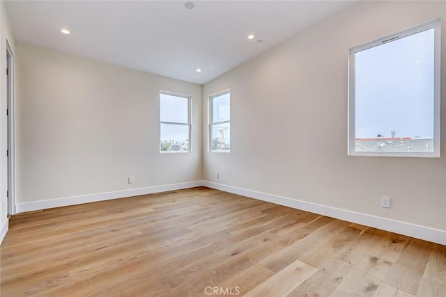 spare room featuring light wood-type flooring