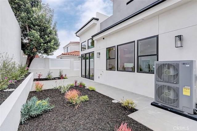 view of side of property with ac unit