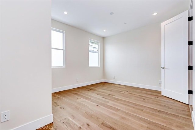 spare room featuring light hardwood / wood-style flooring