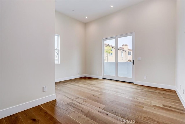 unfurnished room with light wood-type flooring