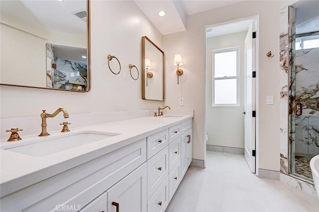 bathroom featuring plenty of natural light, toilet, an enclosed shower, and vanity