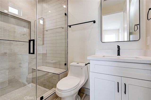 bathroom featuring a shower with door, vanity, hardwood / wood-style floors, and toilet