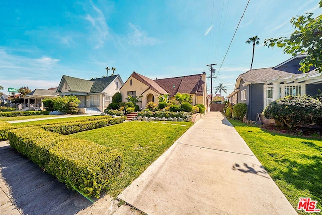 bungalow-style home with a front yard