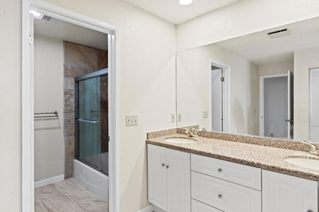 bathroom with enclosed tub / shower combo and vanity