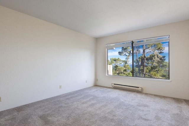 carpeted empty room featuring baseboard heating