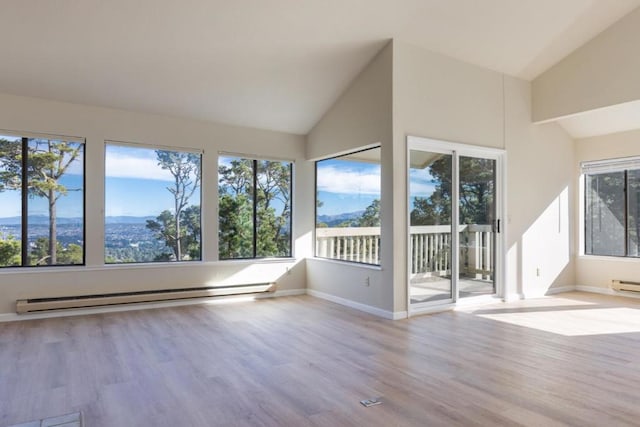 unfurnished sunroom with vaulted ceiling, baseboard heating, and a mountain view