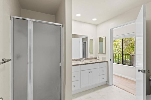 bathroom with an enclosed shower and vanity