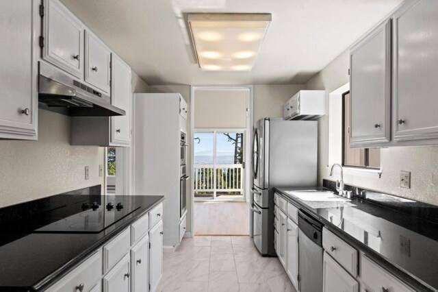 kitchen with sink, white cabinets, and stainless steel appliances