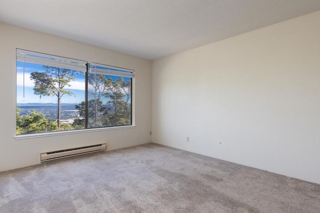 carpeted spare room featuring baseboard heating