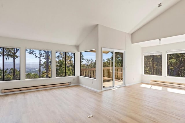 unfurnished sunroom featuring baseboard heating, vaulted ceiling, and a wealth of natural light