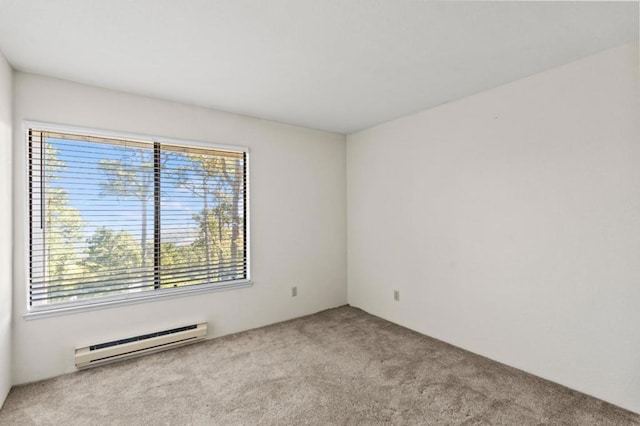 empty room with a baseboard radiator, light colored carpet, and plenty of natural light