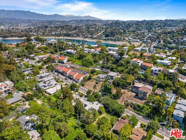 birds eye view of property featuring a water and mountain view