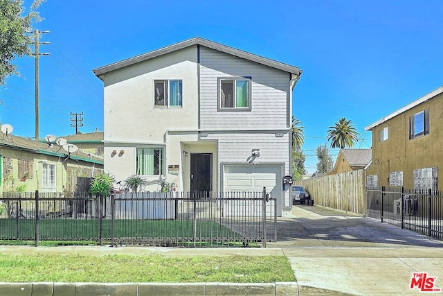 front facade featuring a garage and a front yard