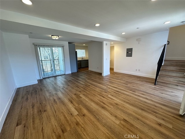 unfurnished living room with french doors, electric panel, and hardwood / wood-style floors