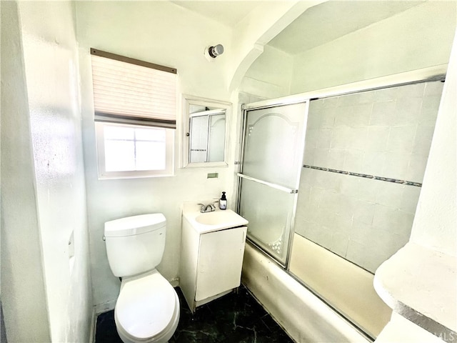 full bathroom with vanity, enclosed tub / shower combo, and toilet