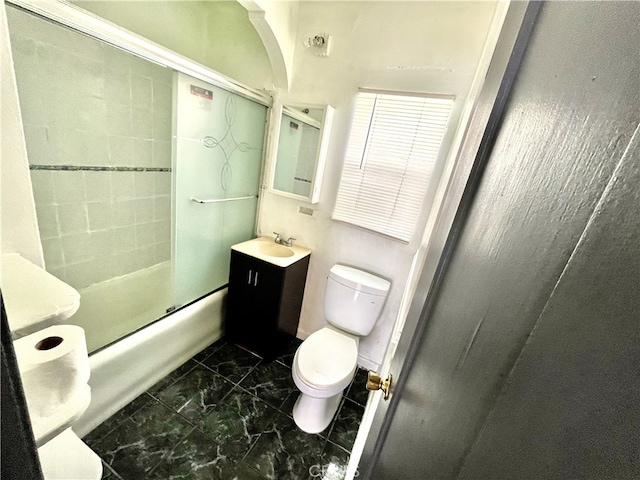 full bathroom with toilet, bath / shower combo with glass door, and vanity