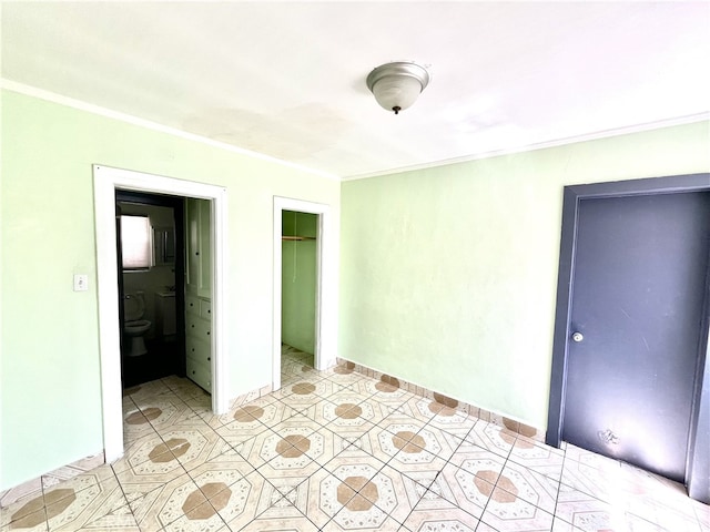 unfurnished bedroom with a closet, ornamental molding, and light tile patterned floors