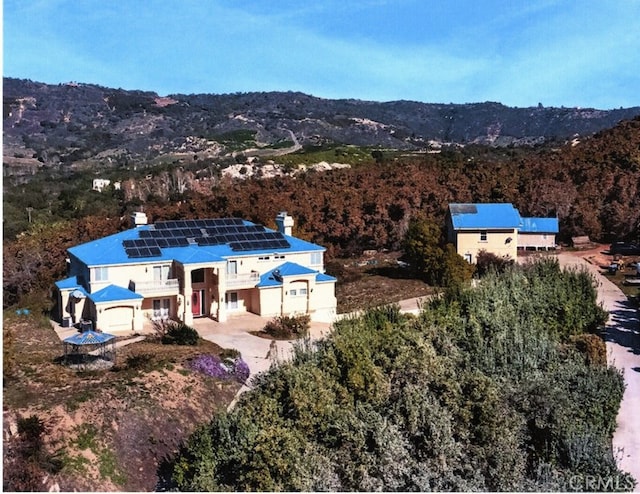 birds eye view of property with a mountain view