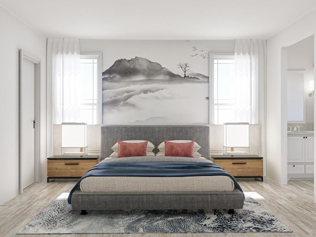 bedroom featuring light hardwood / wood-style flooring and ensuite bath