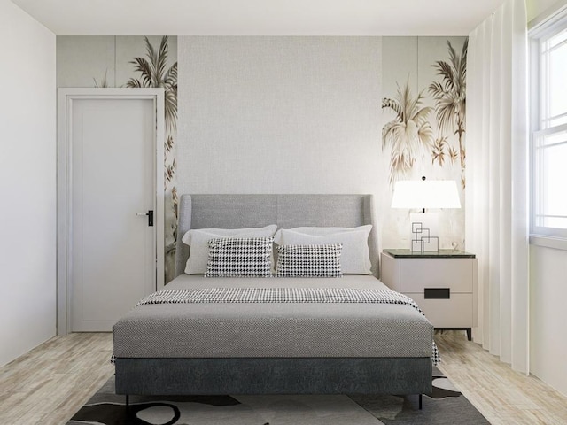 bedroom featuring light hardwood / wood-style flooring and multiple windows