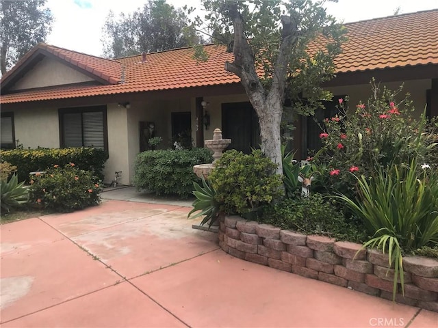 back of property featuring a patio area