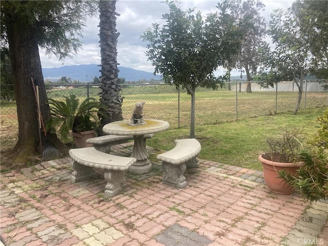 view of patio with a mountain view and a rural view