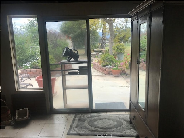 entryway featuring plenty of natural light and light tile patterned flooring