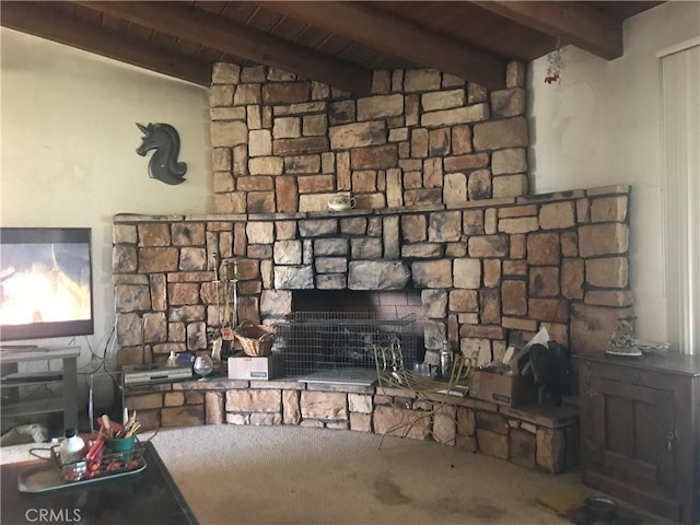 interior space with beamed ceiling, wood ceiling, and a fireplace