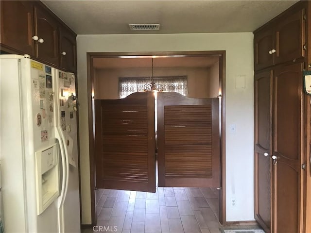 doorway to outside featuring hardwood / wood-style flooring and a notable chandelier