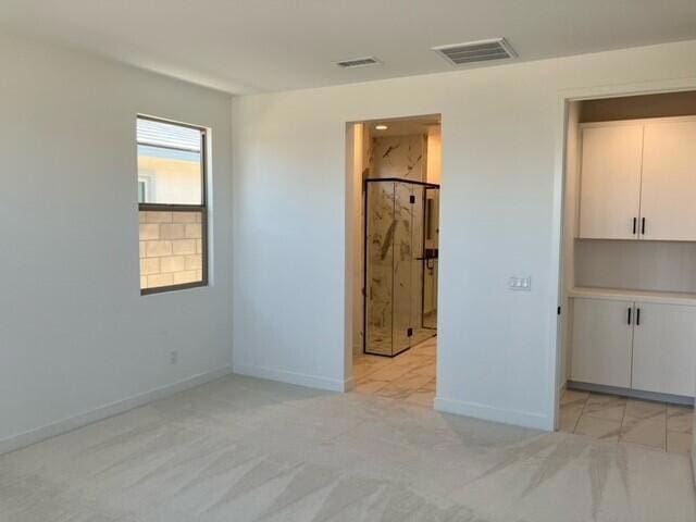 unfurnished bedroom featuring light carpet