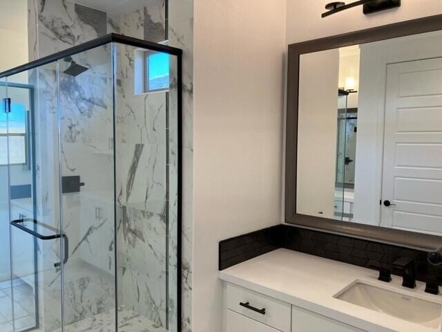 bathroom with vanity and walk in shower