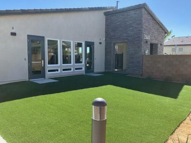 rear view of house featuring a lawn