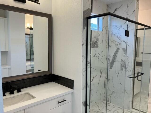 bathroom featuring vanity and an enclosed shower